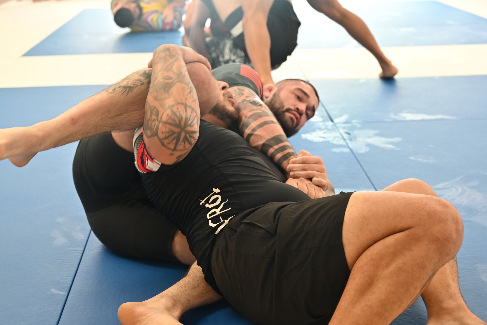 Adults practicing Brazilian Jiu-Jitsu drills at B-52 Jiu-Jitsu Academy in Perry, GA.