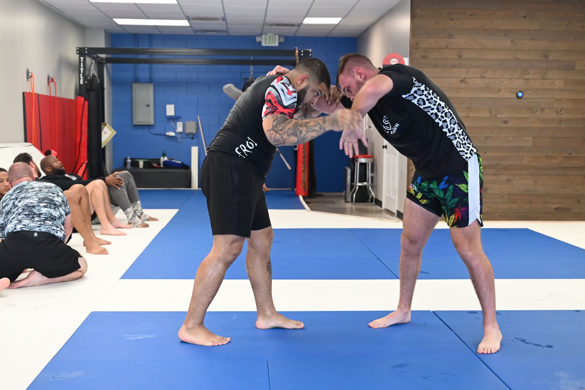 Adults practicing Brazilian Jiu-Jitsu drills at B-52 Jiu-Jitsu Academy in Perry, GA for fitness.