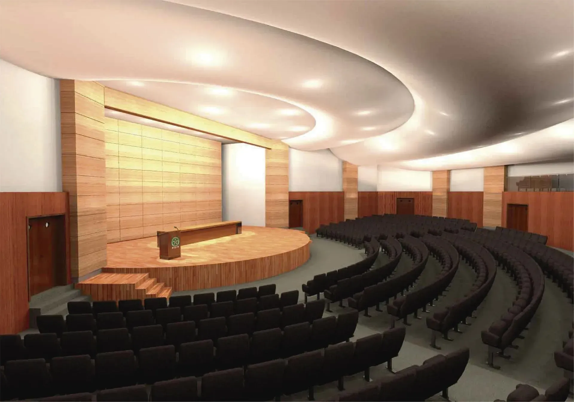 Auditorio con gradas curvas frente a un escenario de madera con atril. Las paredes están revestidas con paneles de madera.