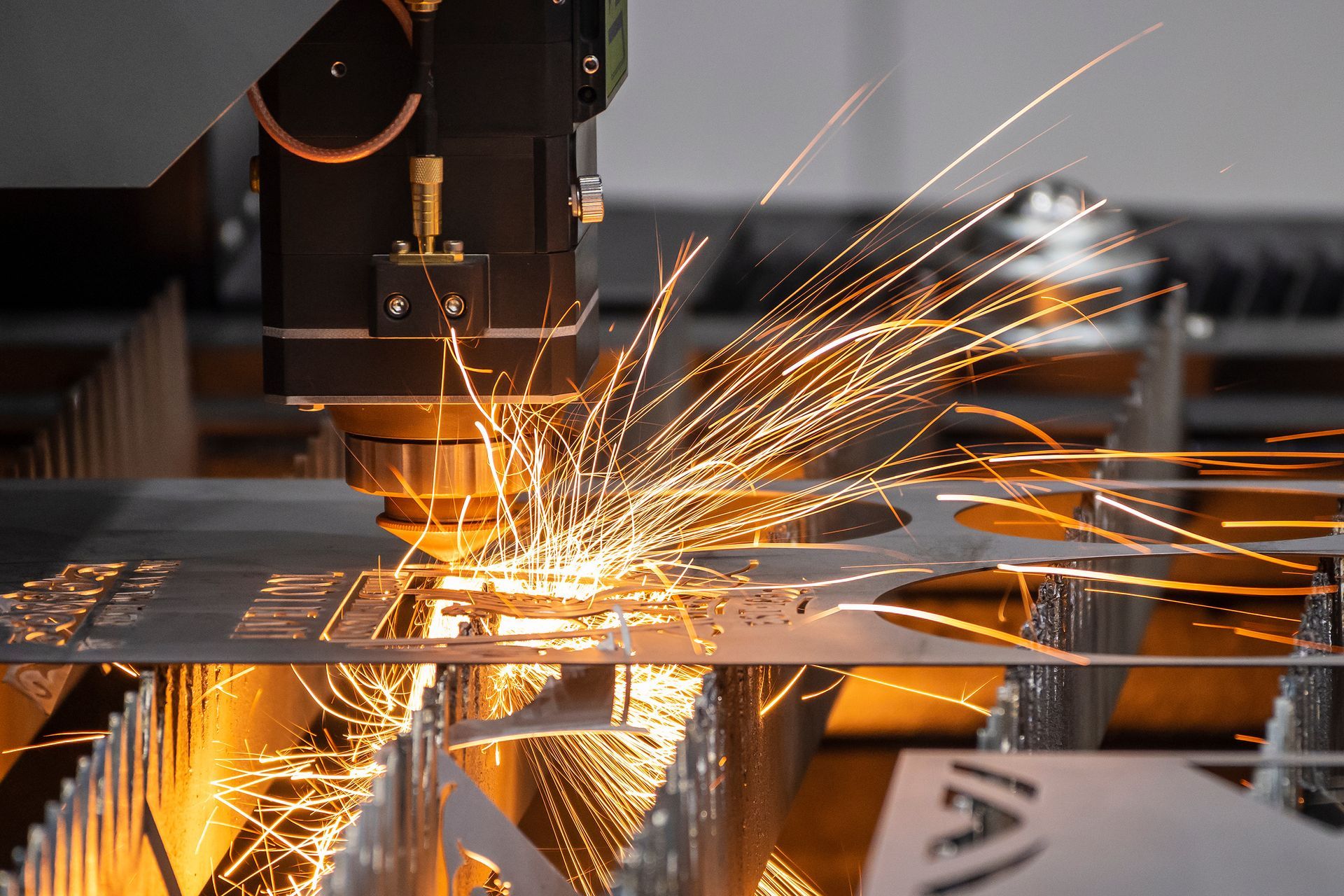 Industrial metal fabrication laser cutting steel with sparks