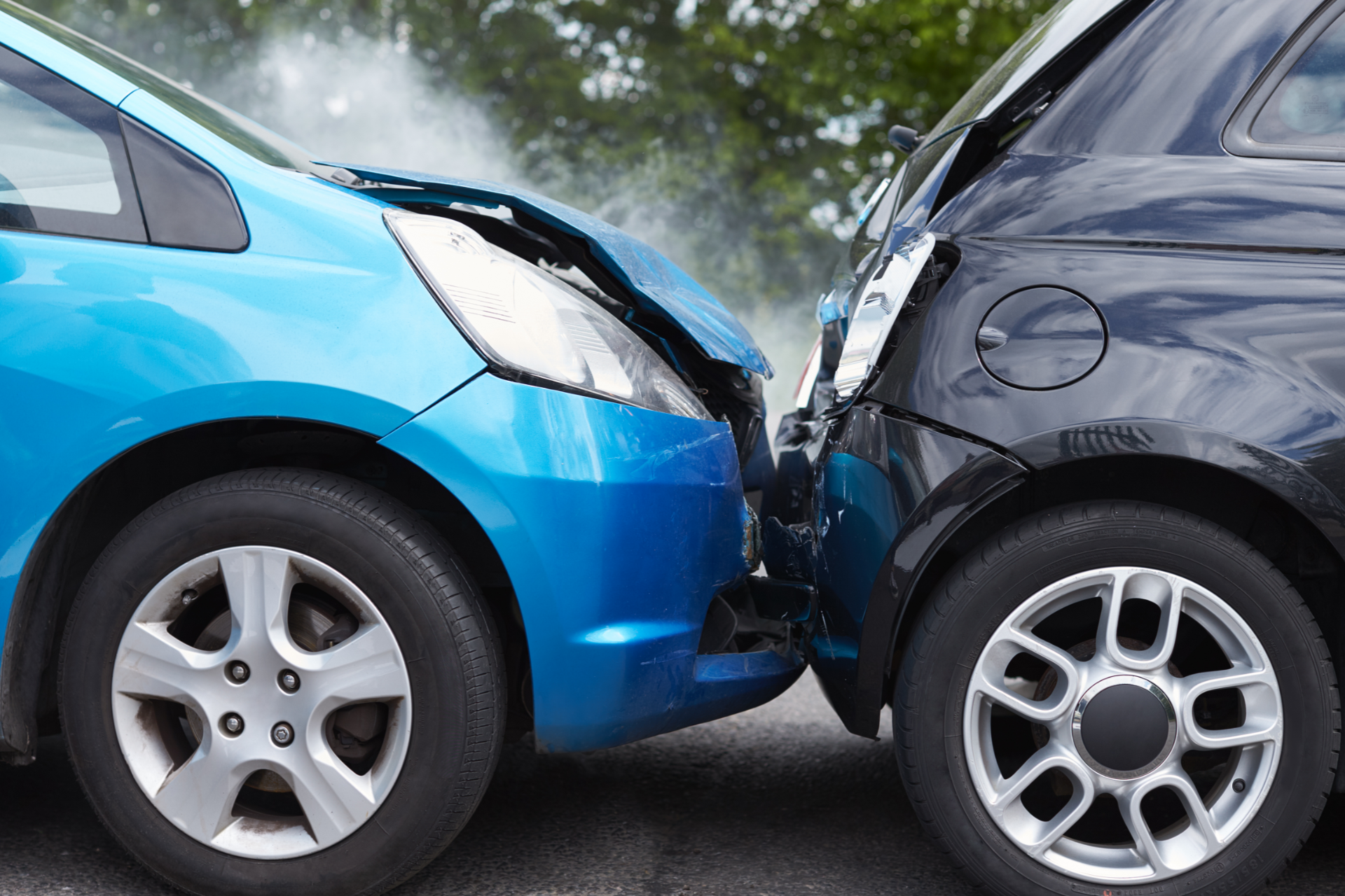 Man in plaid shirt smiles at child from car window.