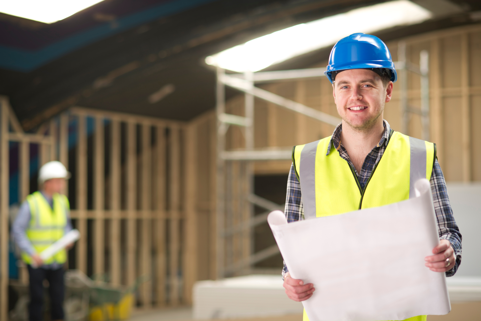 Man in plaid shirt smiles at child from car window.