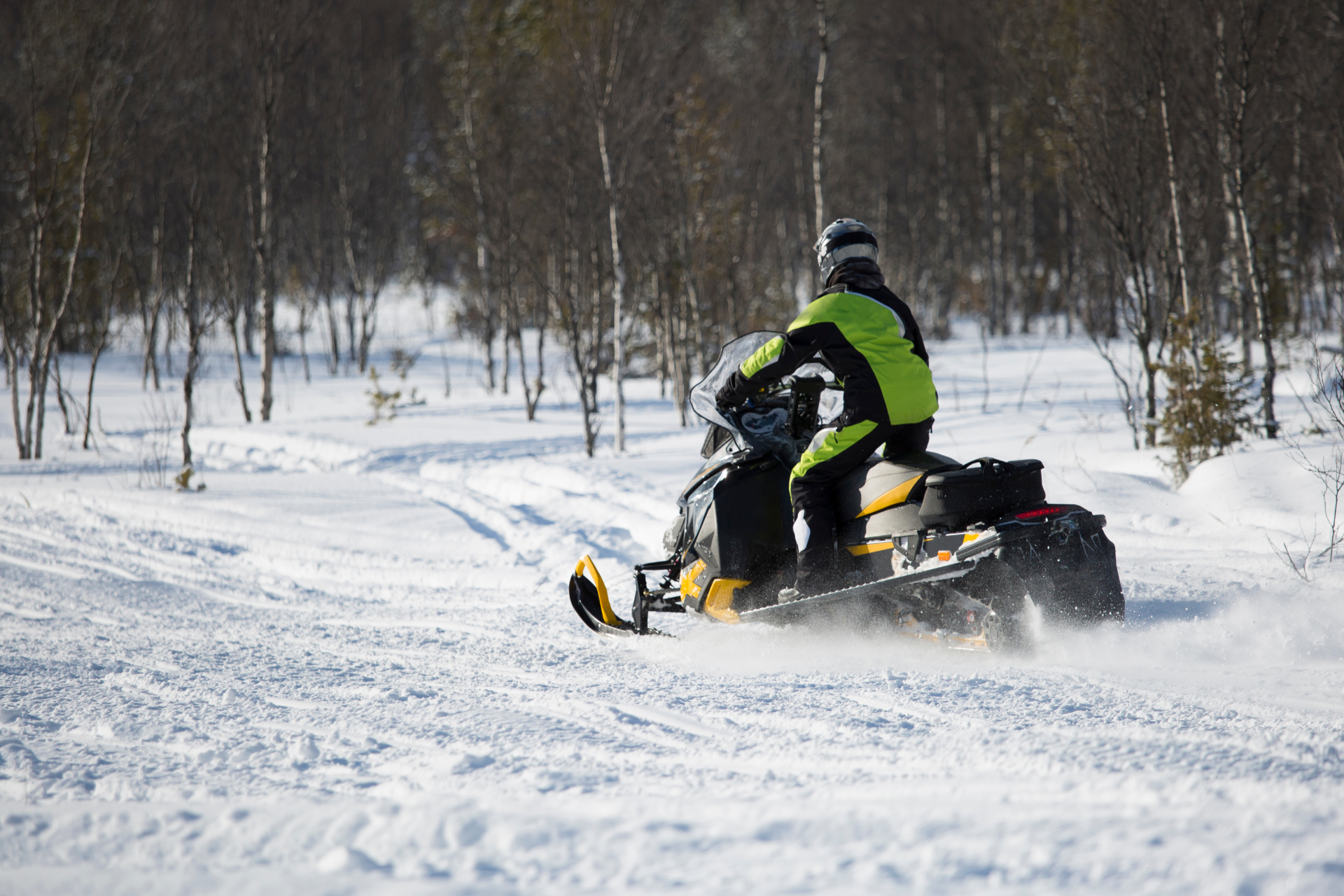 Man in plaid shirt smiles at child from car window.