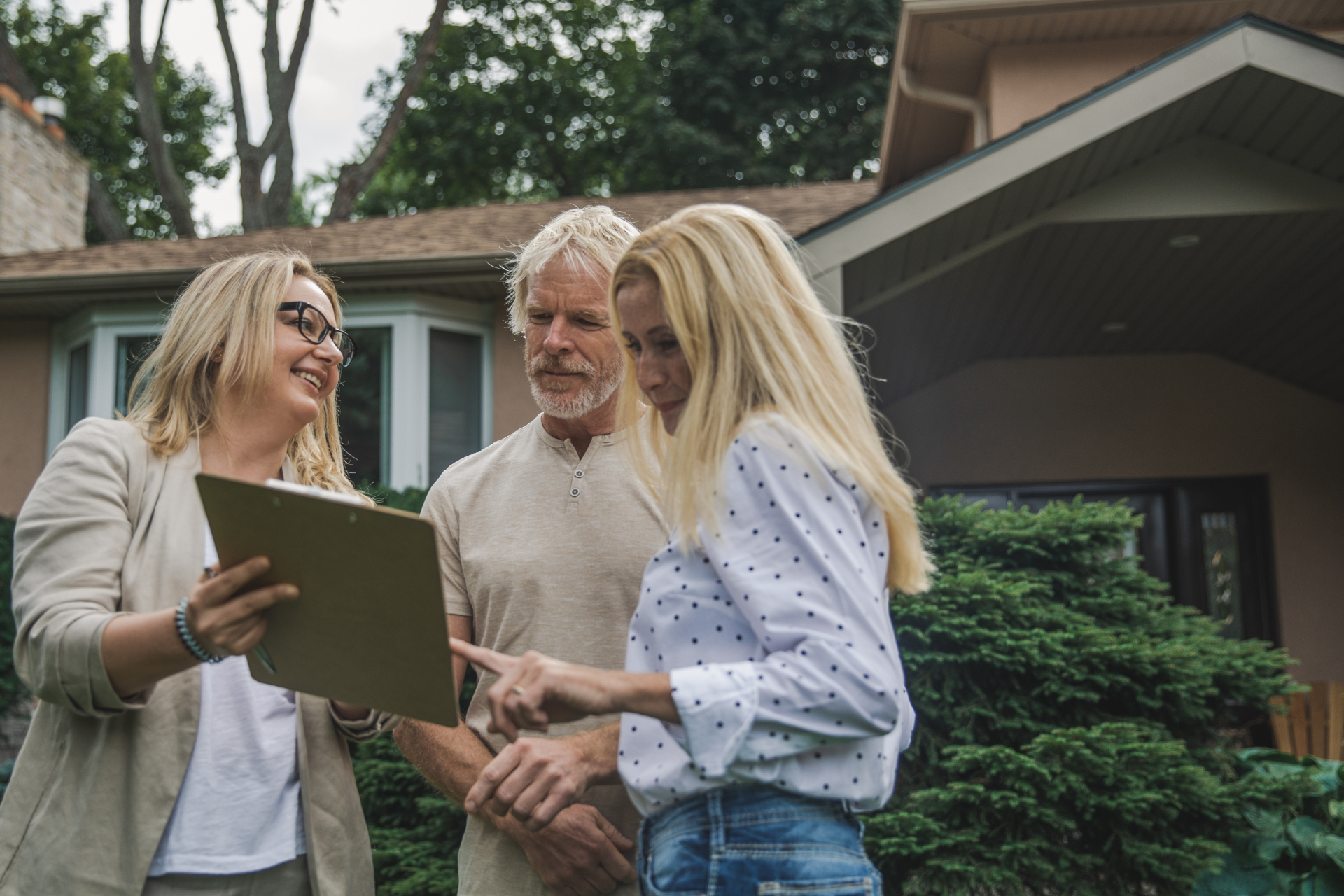 Man in plaid shirt smiles at child from car window.