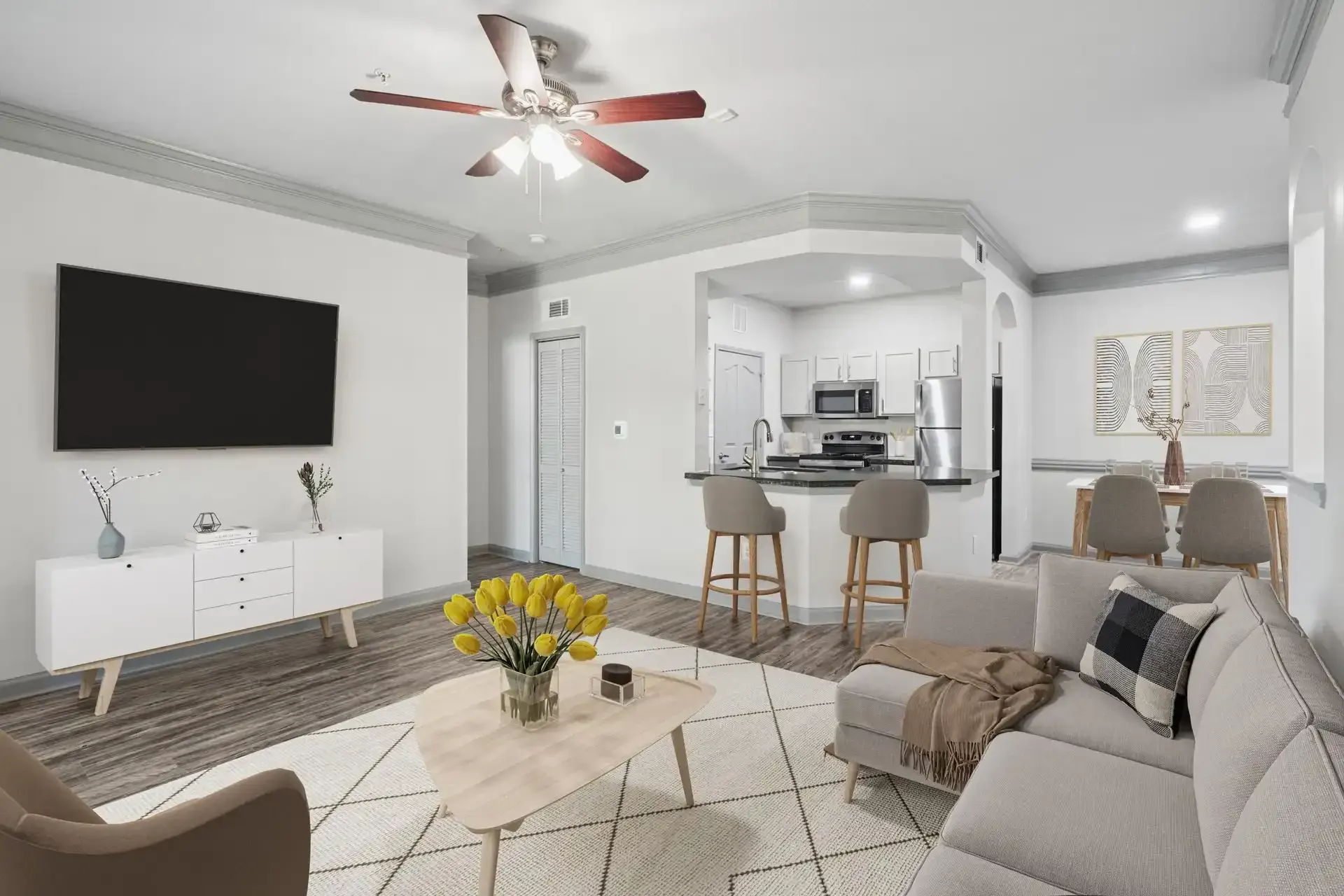 Cozy living room with sectional sofa, TV, and open kitchen with breakfast bar.