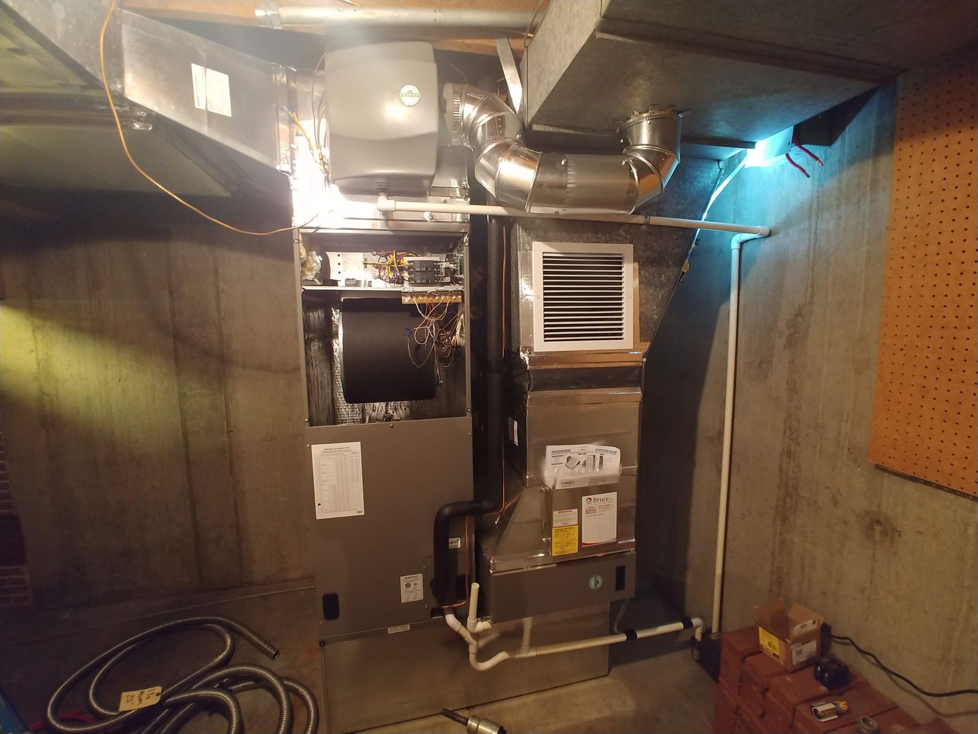 A picture of an air conditioner in a basement.
