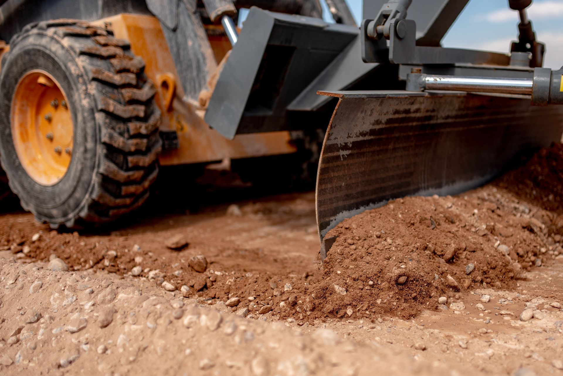 Bulldozer blade grading dirt on a construction site.