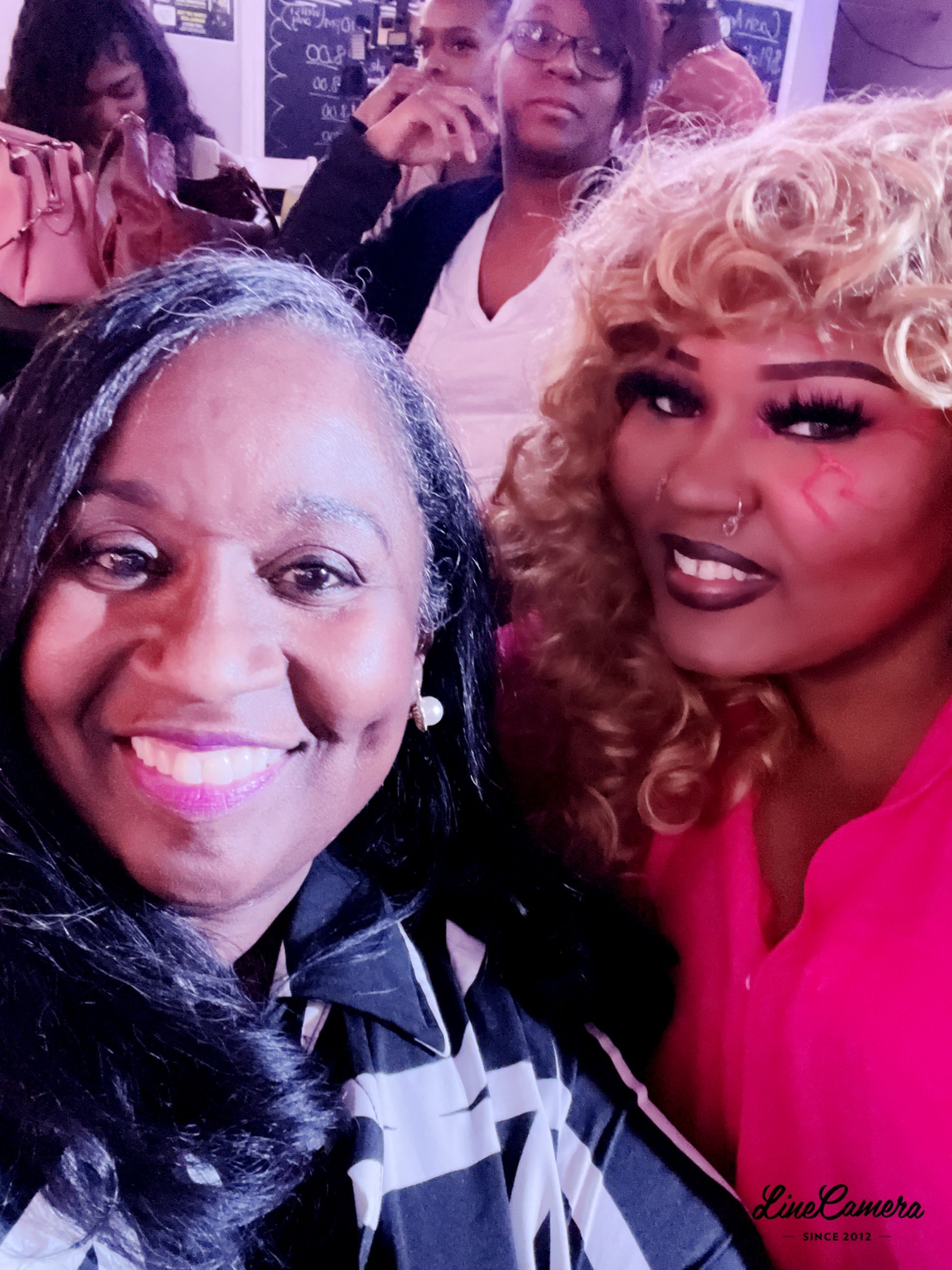 Two women are posing for a picture and one has a nose ring