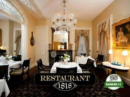 Restaurant 1818 dining room with white tablecloths, chandelier, and ornate decor. Ranked #1.