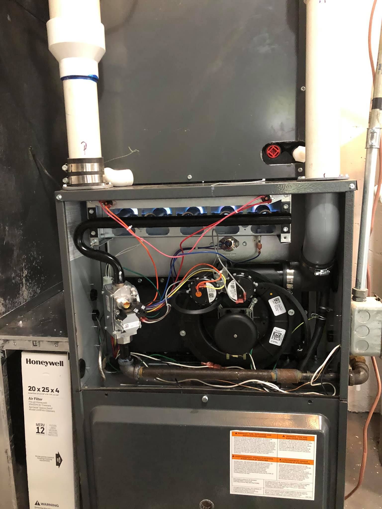 Exposed furnace wiring and components during HVAC system maintenance
