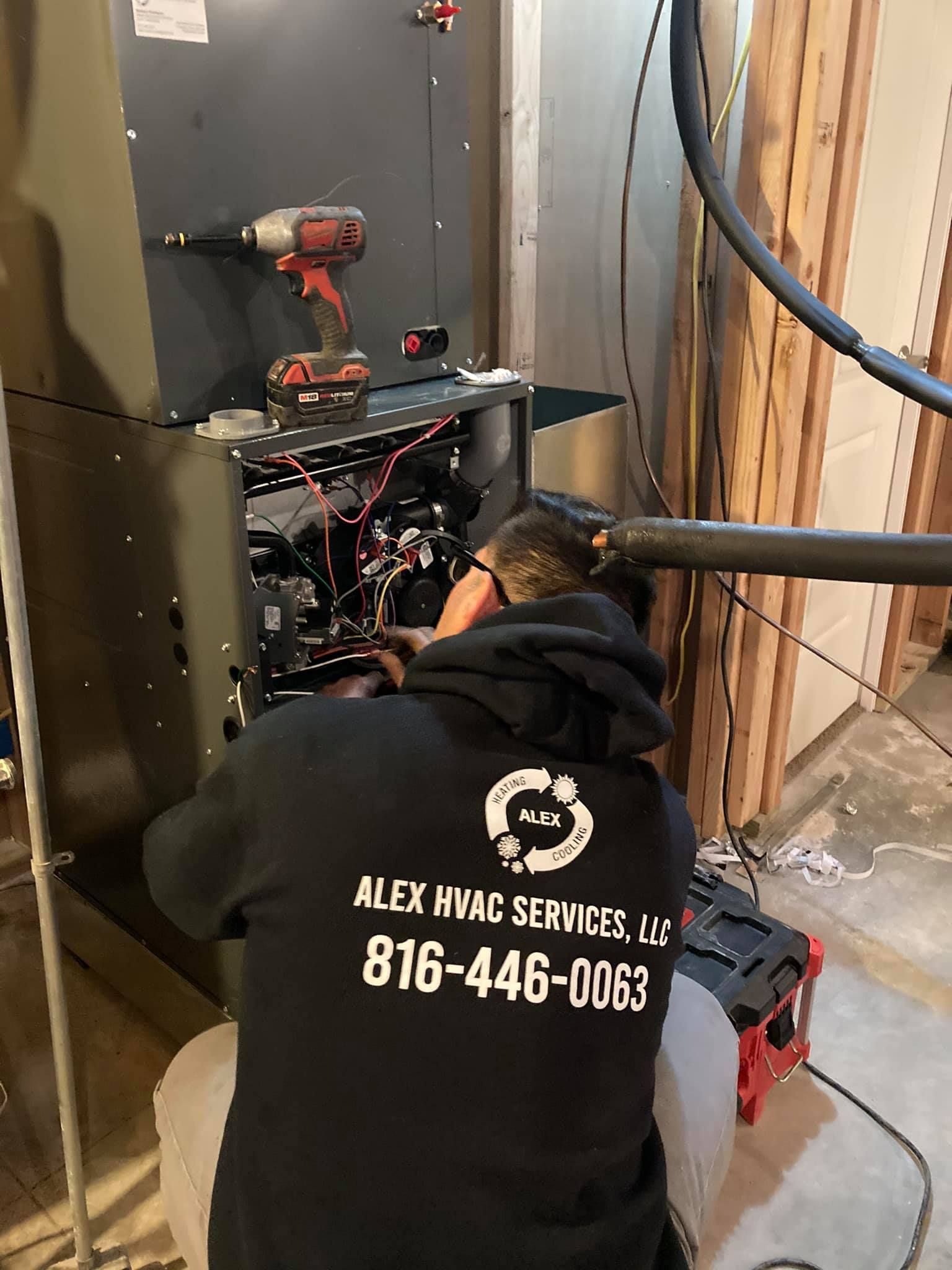 HVAC technician from Alex HVAC Services performing AC repair indoors