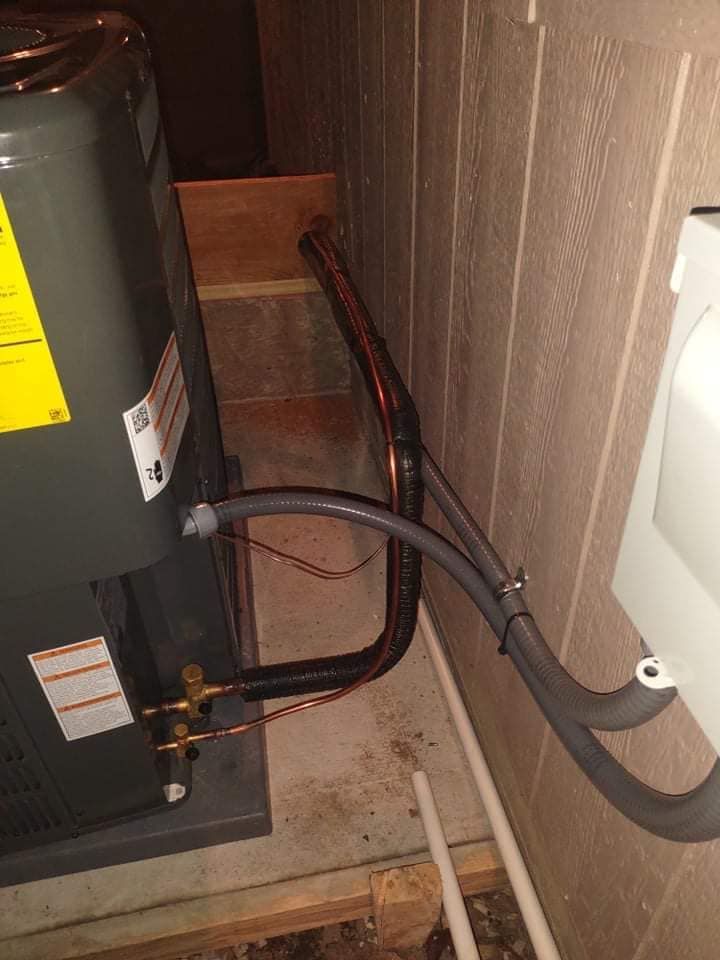 Close-up of HVAC copper piping and ductwork installation on exterior wall