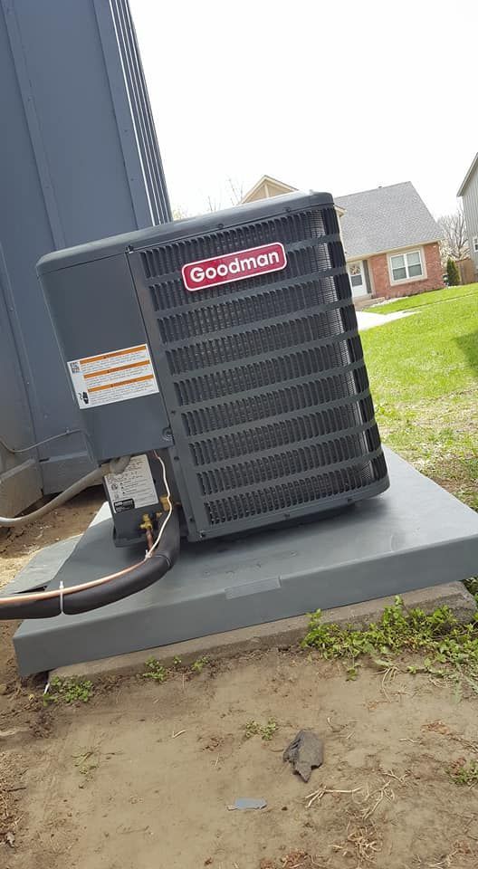 Goodman air conditioner installed on concrete slab outside residential home