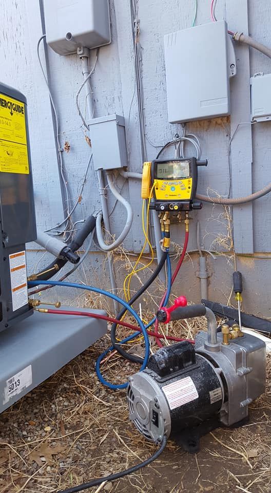 A machine is being installed on the side of a building.