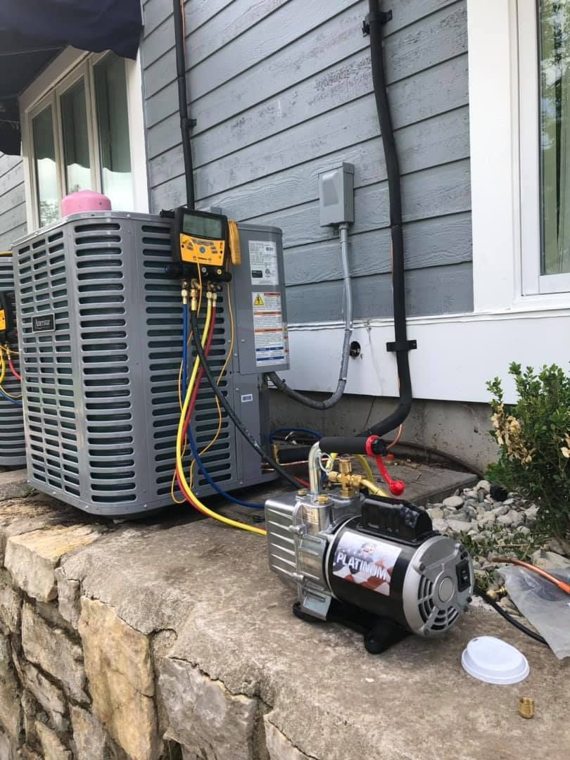 AirEase HVAC system maintenance with vacuum pump and refrigerant gauges
