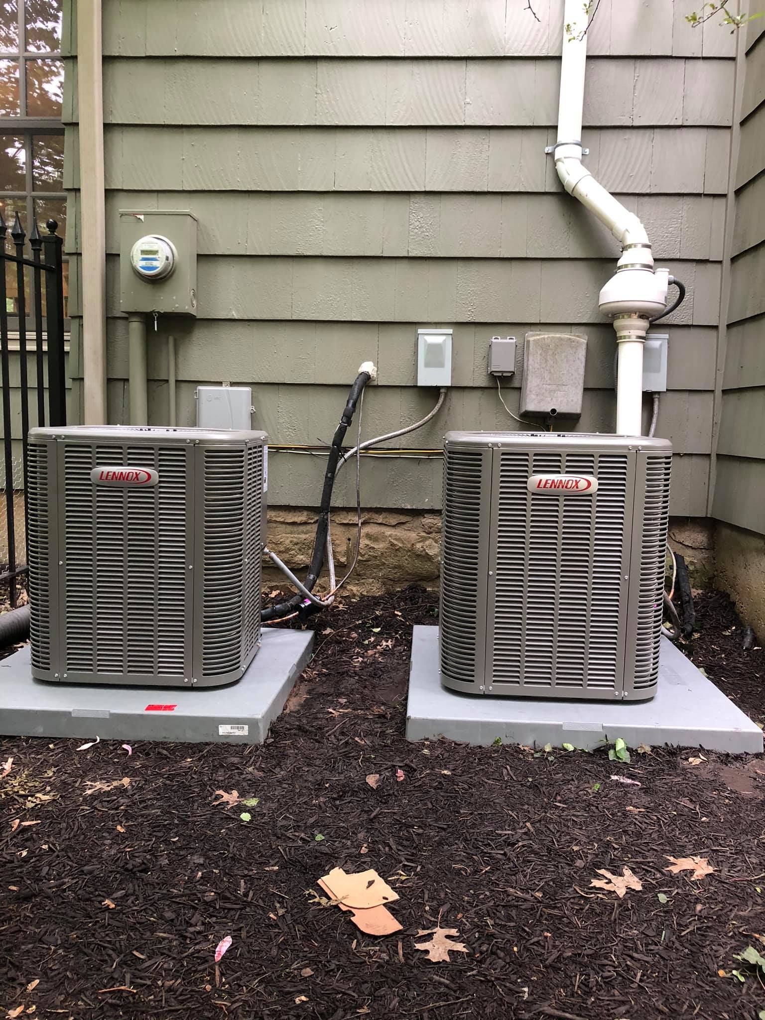 Lennox outdoor HVAC condensers installed side by side for dual-zone cooling