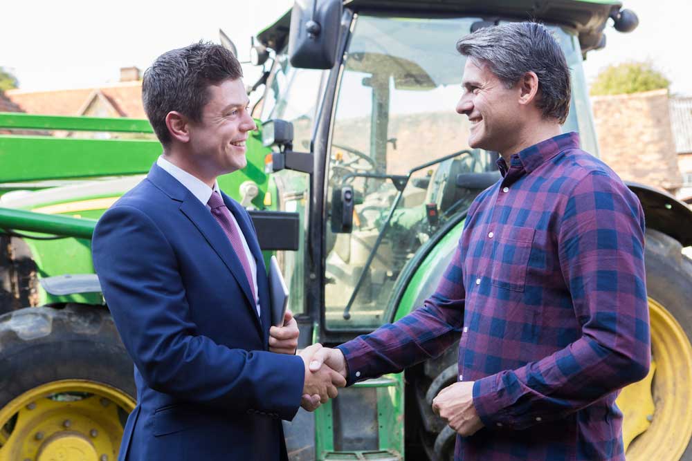 Farmer And Businessman Shaking Hands — Premium Gardening Supplies in Gympie, QLD