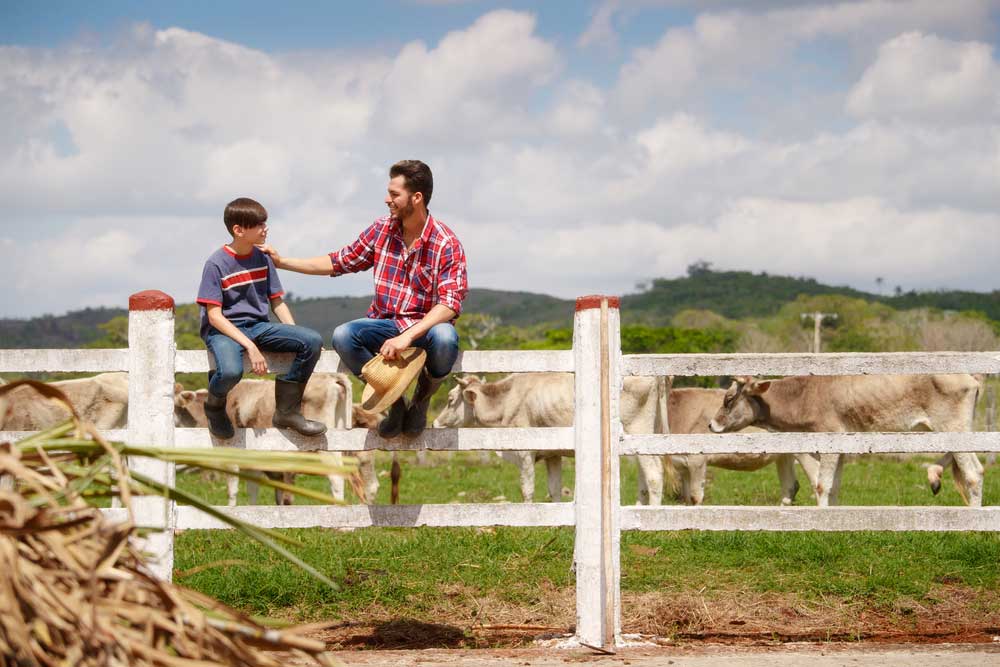 Happy Father And Son Sitting And Smiling In Farmer — Premium Gardening Supplines in Cooroy, QLD
