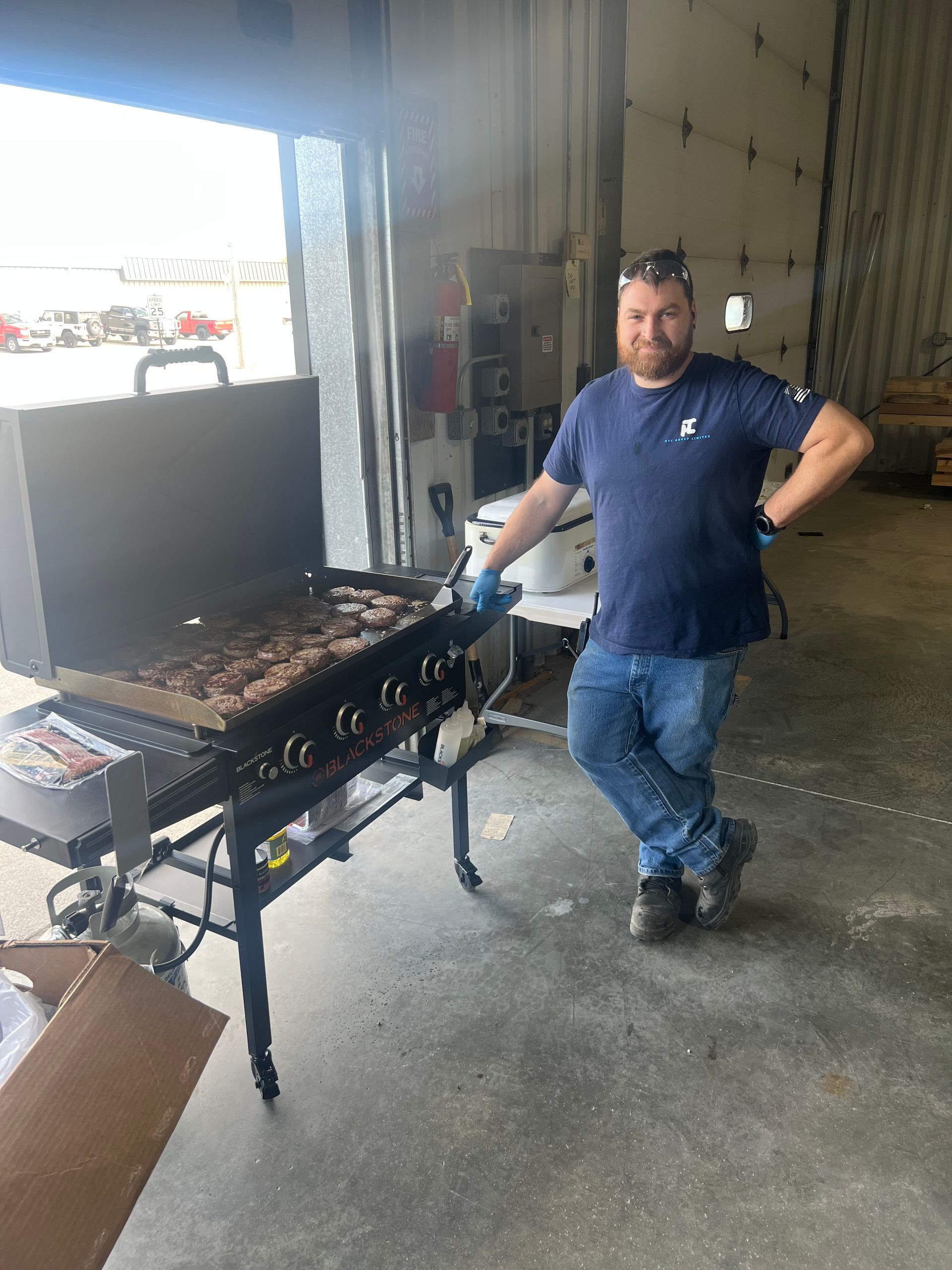 Sean cooking burgers on grill