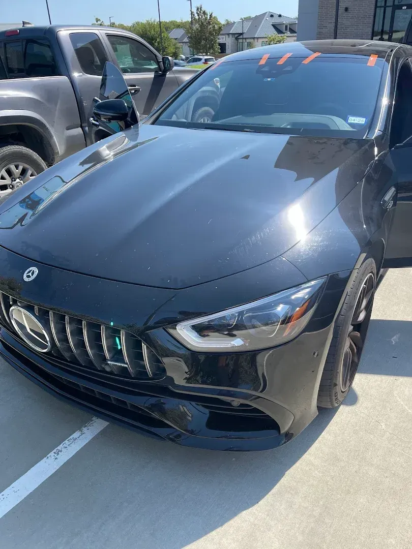 Black Mercedes-AMG GT car parked on a bright, sunny day.