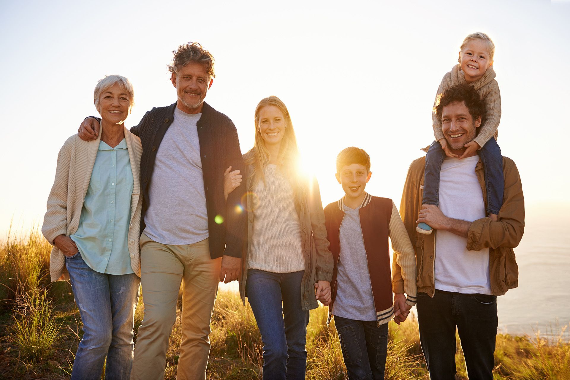 Multigenerational family together at sunset