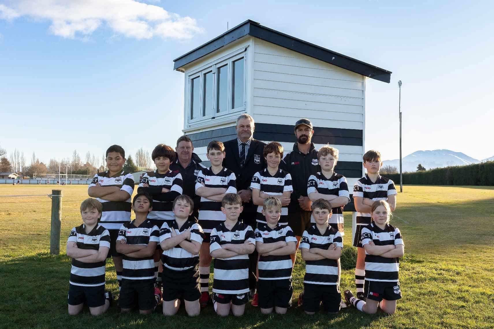 A group of boys posing for a picture with their arms crossed
