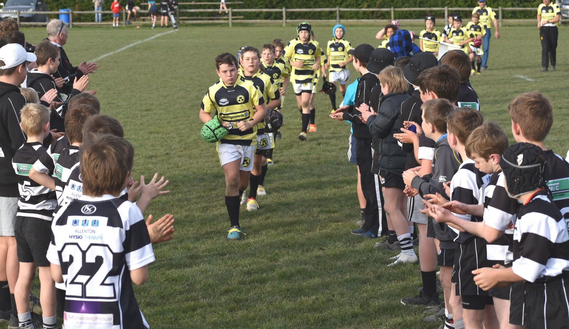 A boy wearing a black and white jersey with the number 22 on it