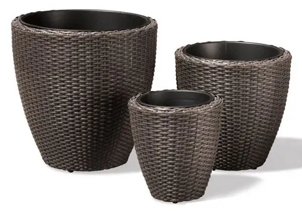 Three woven brown planters of different sizes.