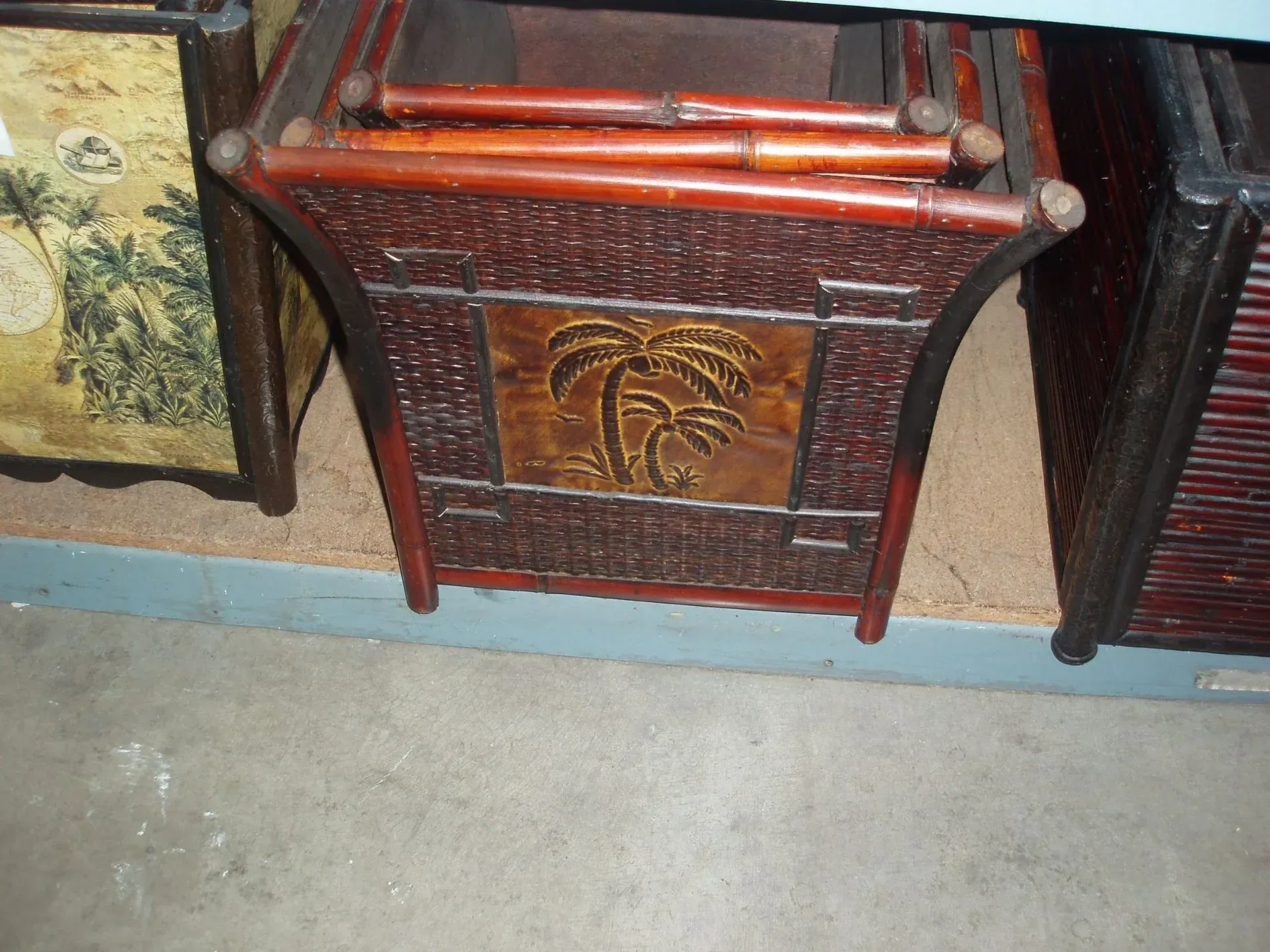 Woven brown bamboo planter with palm tree design.