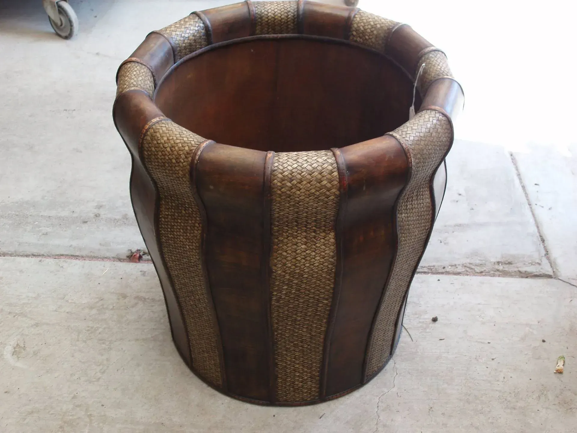 Dark brown wicker basket with dark brown vertical stripes.