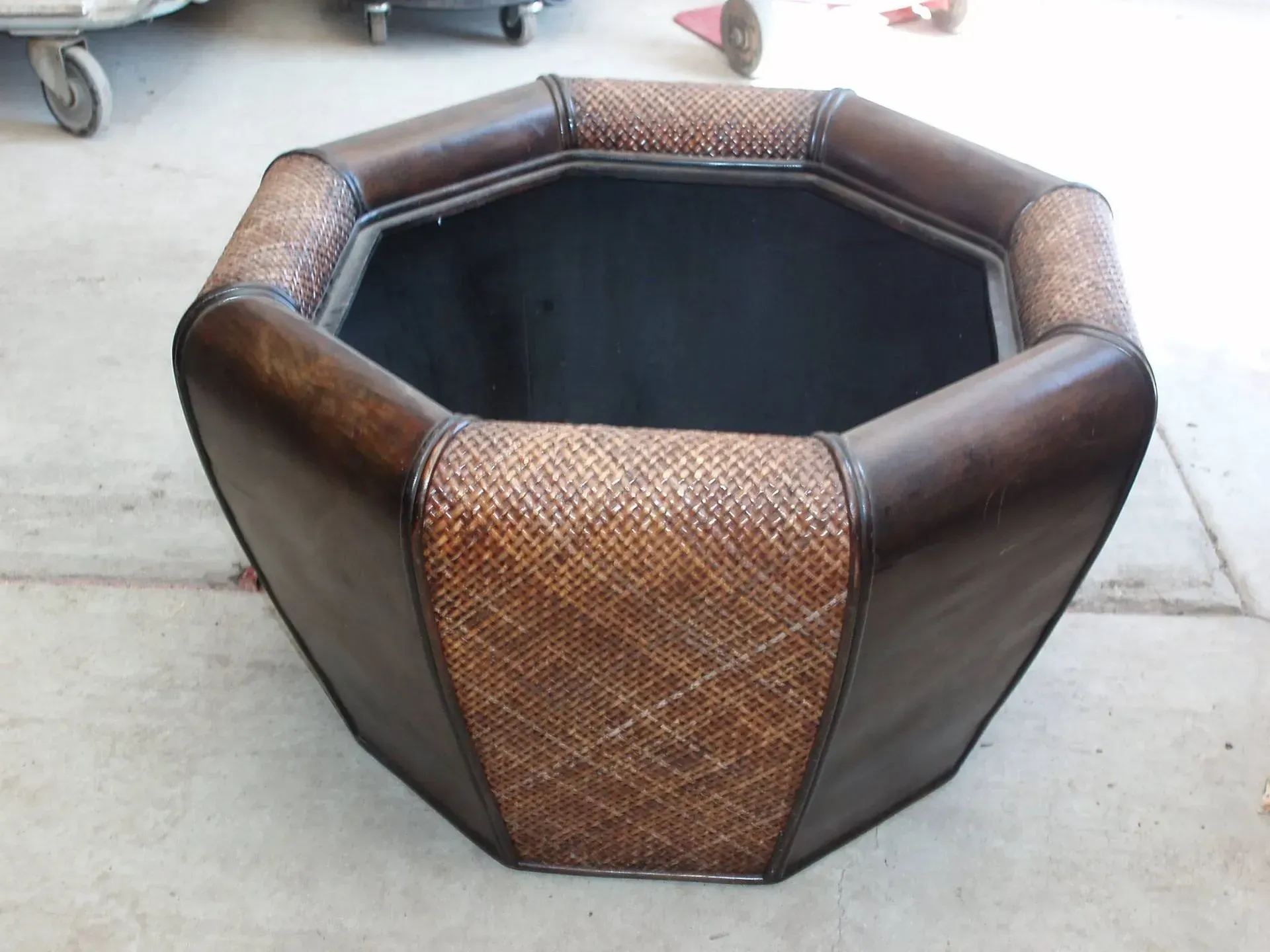 Octagonal planter with dark brown leather and woven sections.