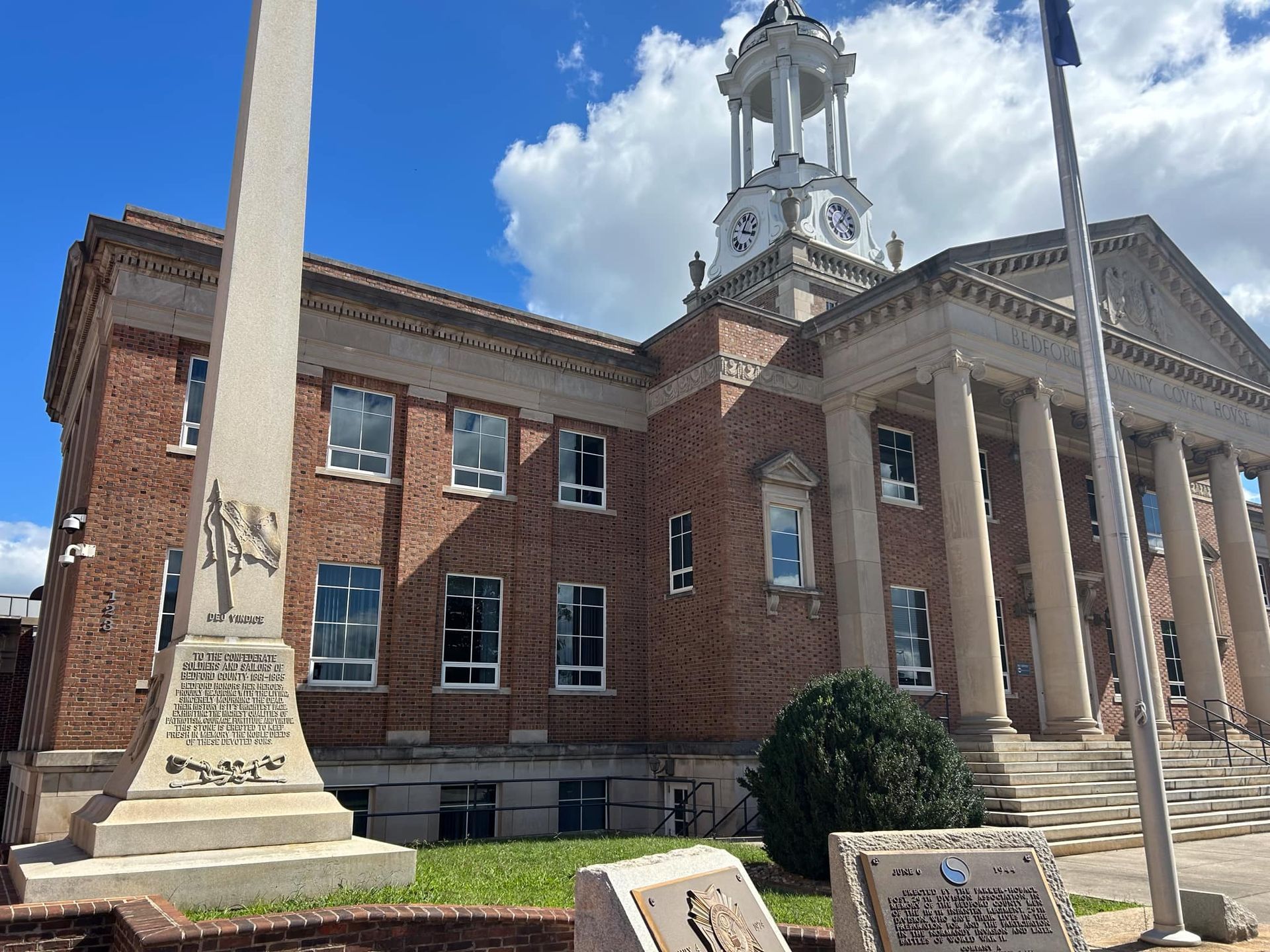 A large brick building with a flag in front of it