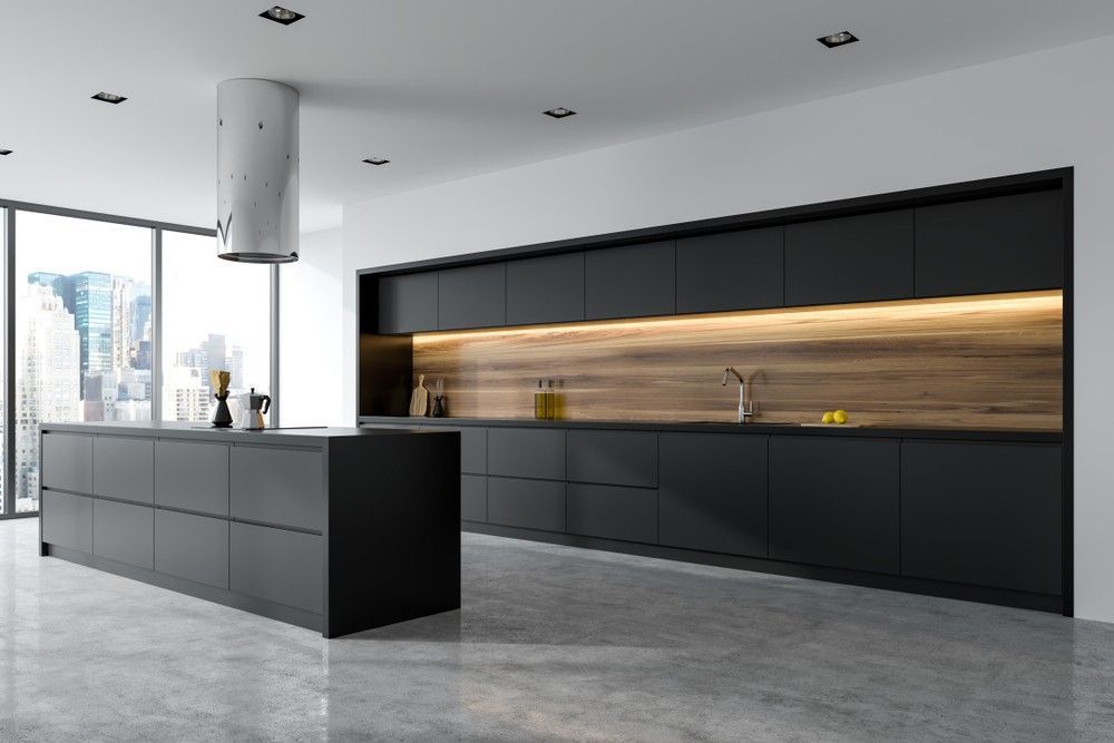 A Modern Kitchen With Black Cabinets and a Large Island in the Middle — Elite Stone in Byron Bay, NSW
