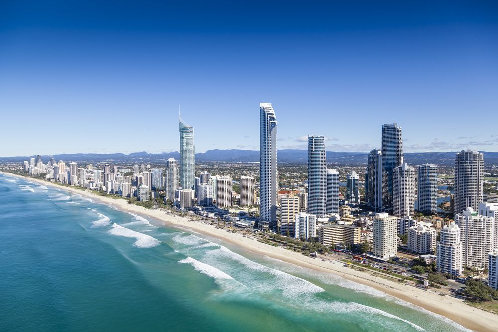 Aerial View of a Coastal City With Turquoise Water, Blue Sky, and White Clouds — Elite Stone in Gold Coast, QLD