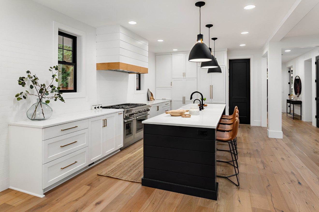 A Kitchen With White Cabinets and a Black Island — Elite Stone in Sunshine Coast, QLD