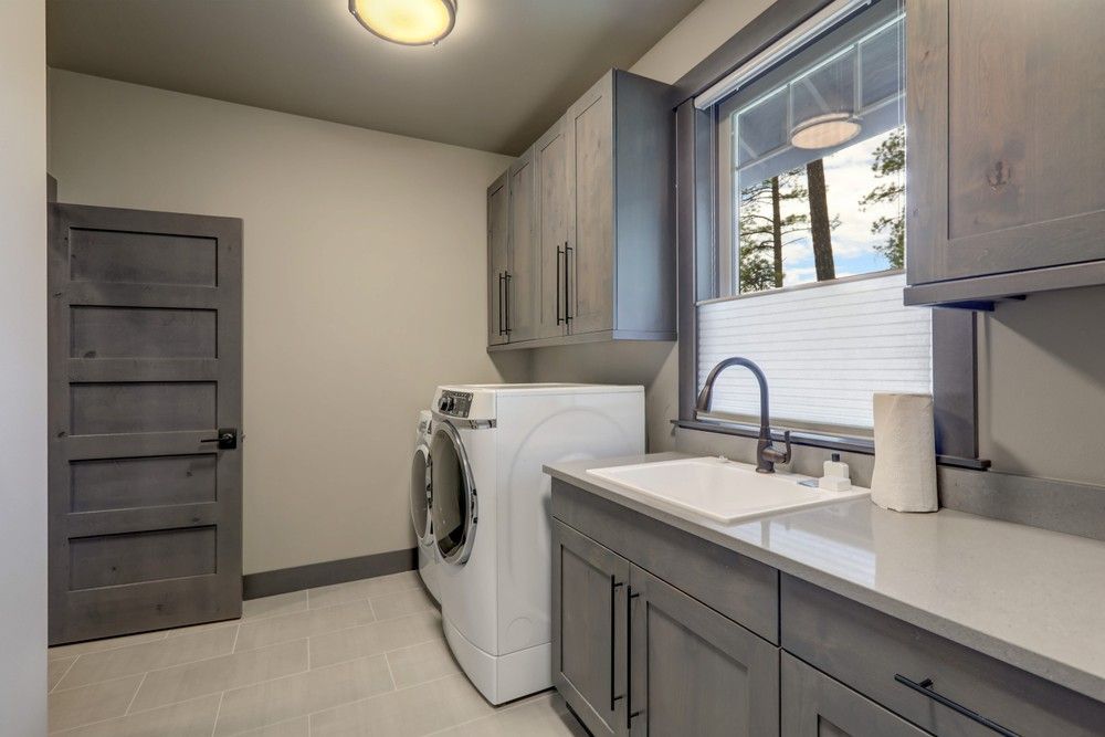 A Laundry Room With a Washer and Dryer and a Sink — Elite Stone in Tweed Heads South, NSW