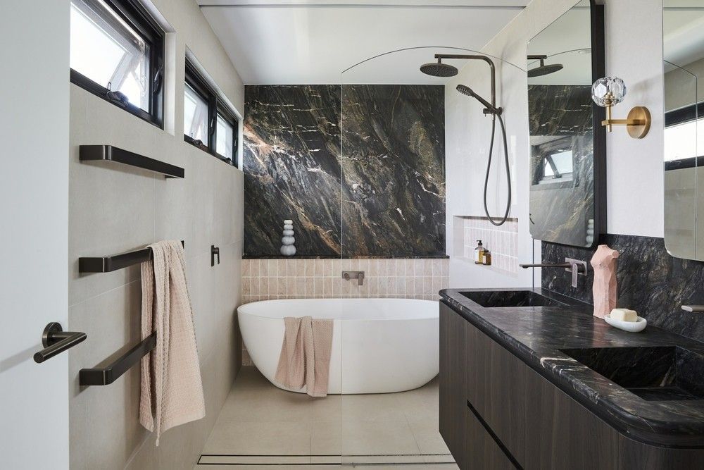 A Bathroom With a Bathtub, Sink and Mirror — Elite Stone in Gold Coast, QLD