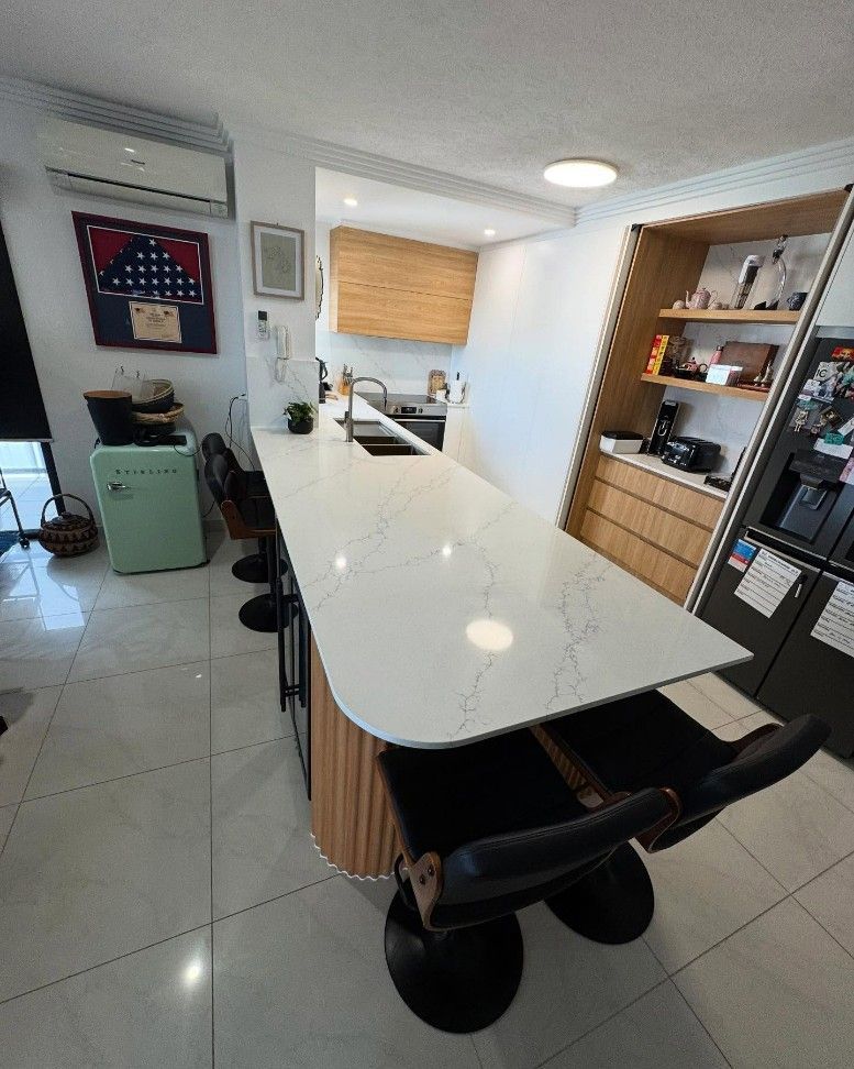 A Kitchen With a Long Table and Chairs and a Refrigerator — Elite Stone in Tweed Heads South, NSW