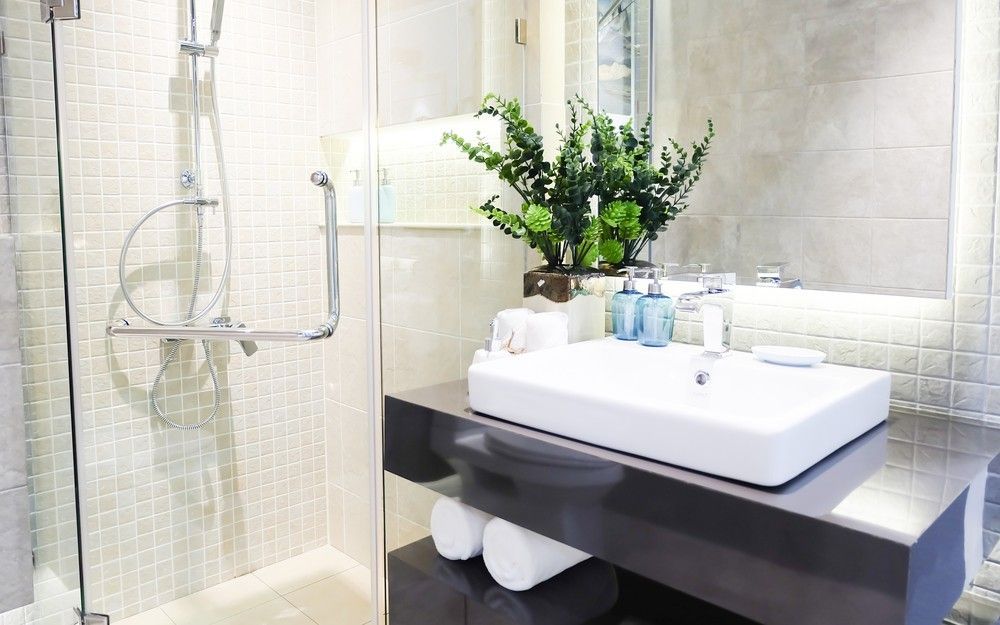 A Bathroom With a Sink, Shower and Mirror — Elite Stone in Tweed Heads South, NSW