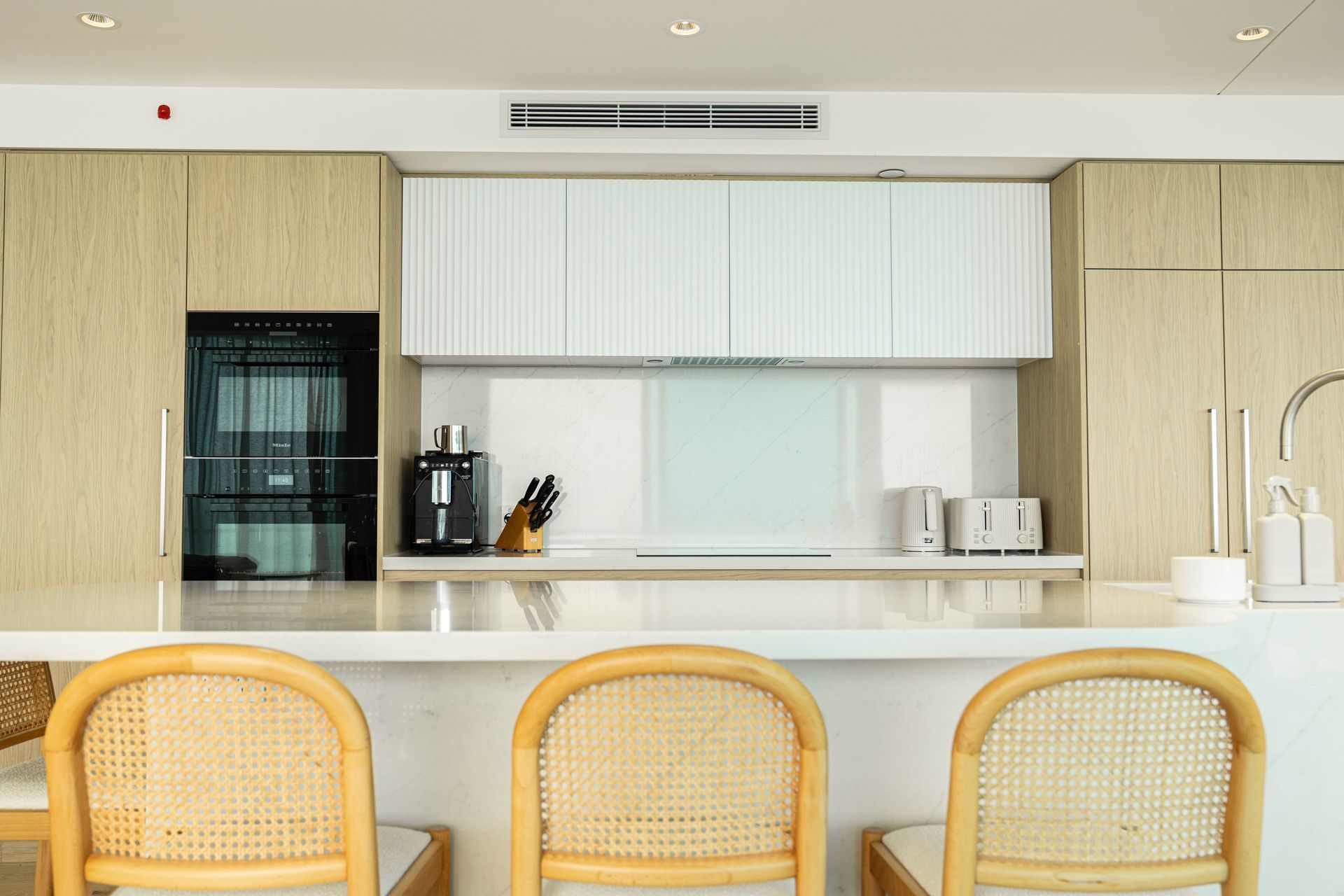 A Modern Kitchen Features Light Wood Cabinets and Built-in Appliances — Elite Stone in Tweed Heads South, NSW
