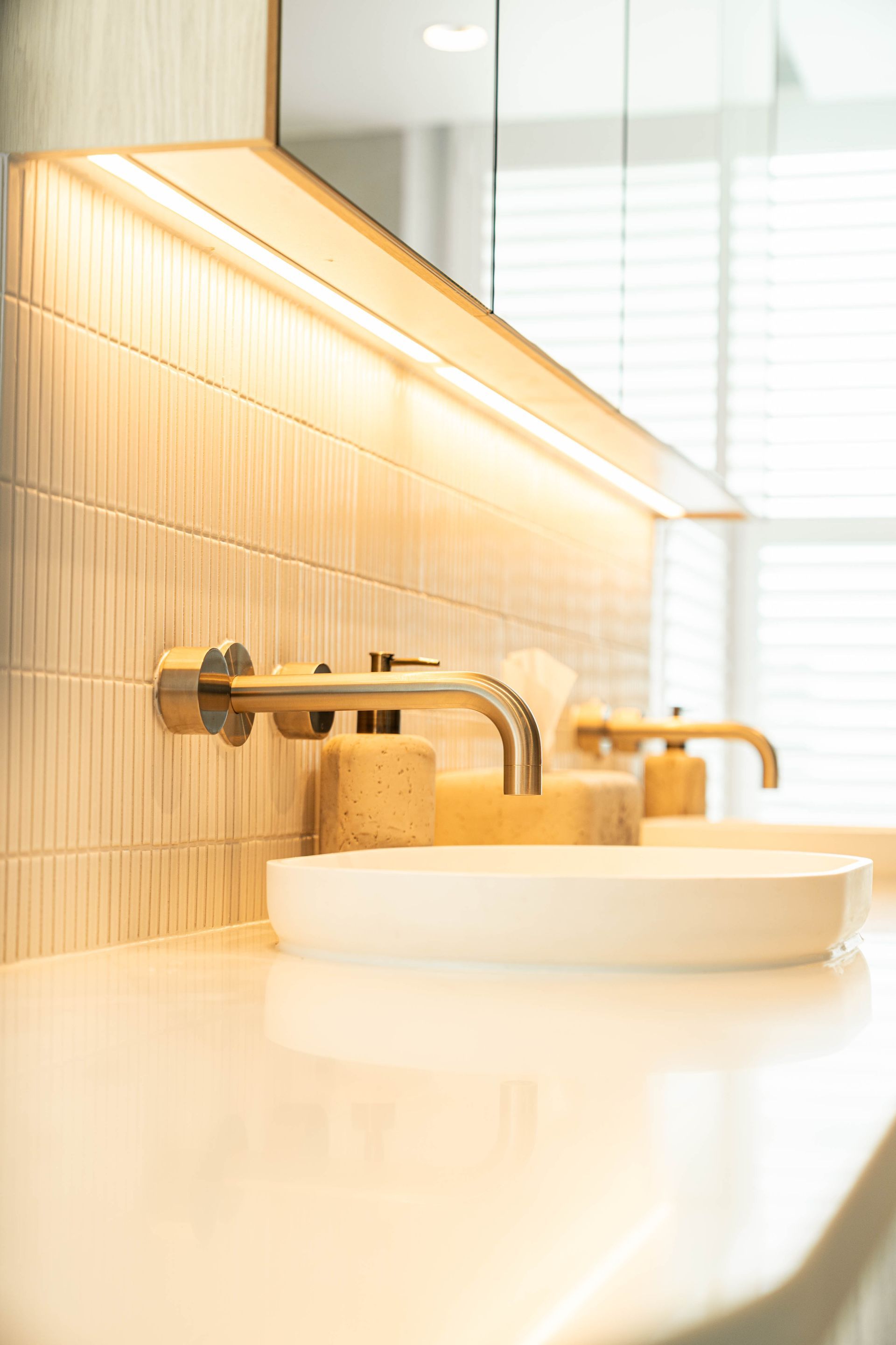 Modern Bathroom Vanity With a White Vessel Sink, Gold Faucet, and Textured Wall Tile — Elite Stone in Tweed Heads South, NSW