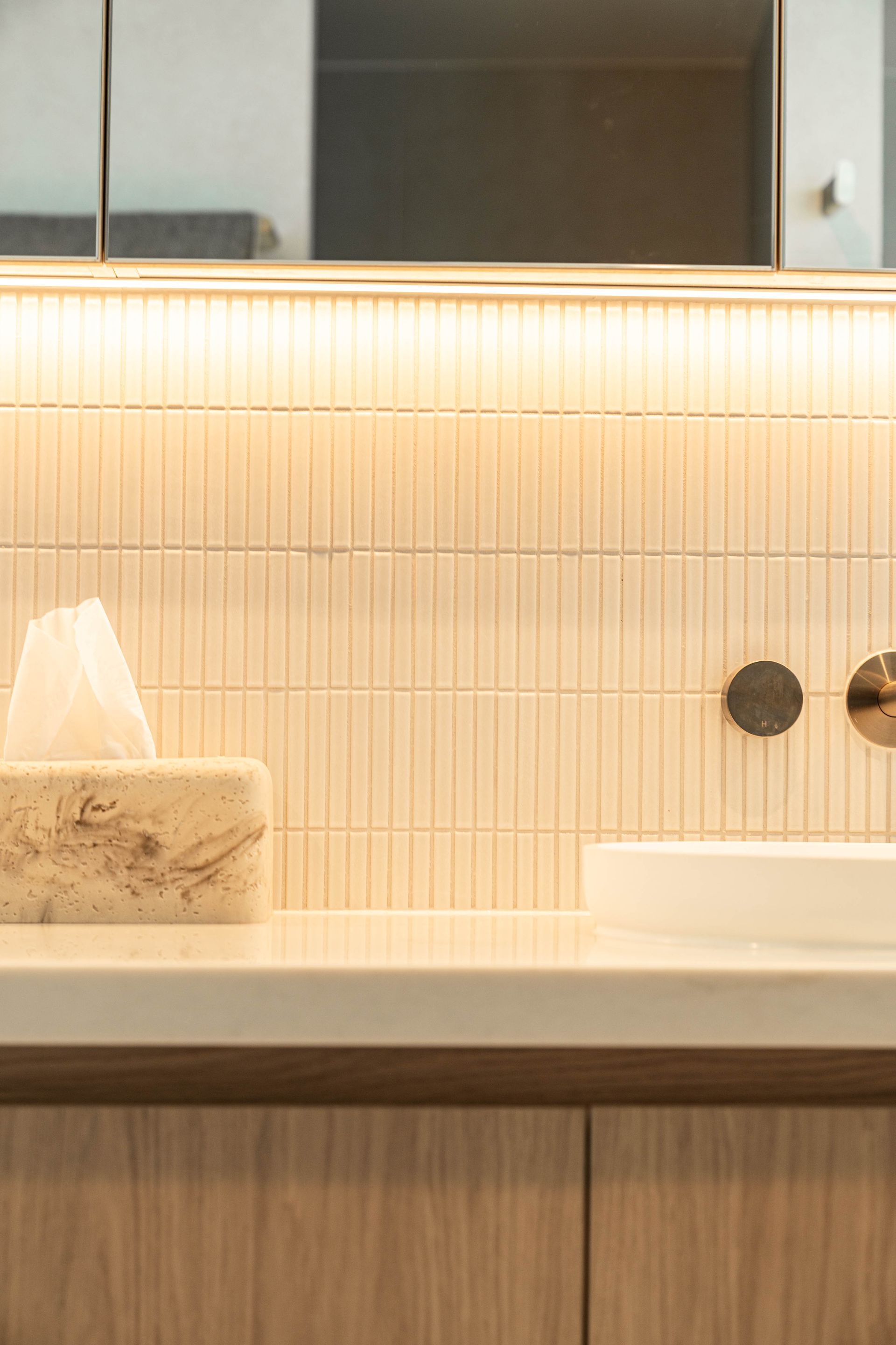 A Modern Bathroom Vanity With a Textured Cream-colored Tile Backsplash — Elite Stone in Tweed Heads South, NSW