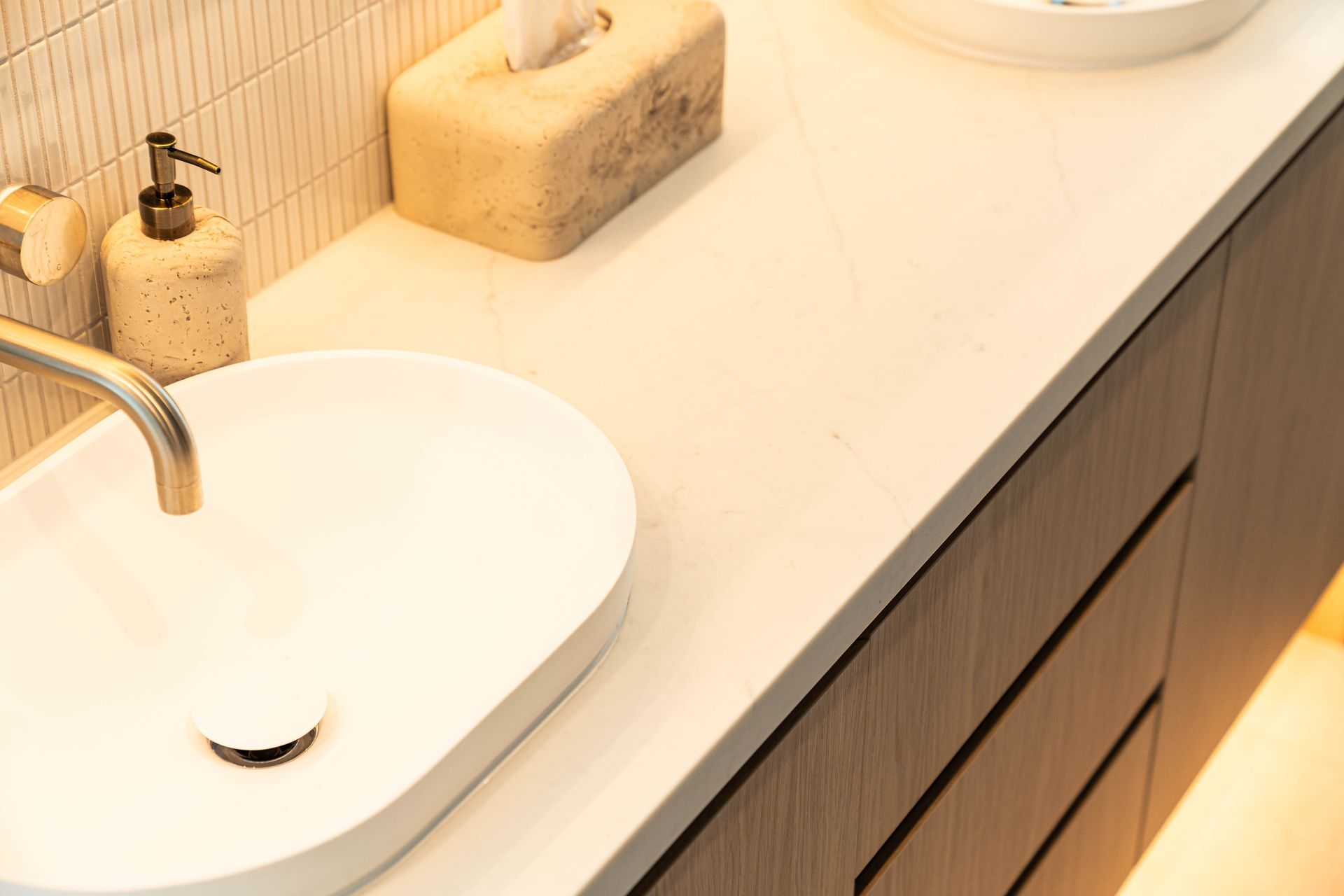 A Modern Bathroom Vanity With a White Vessel Sink, and Dark Wood Drawers — Elite Stone in Tweed Heads South, NSW