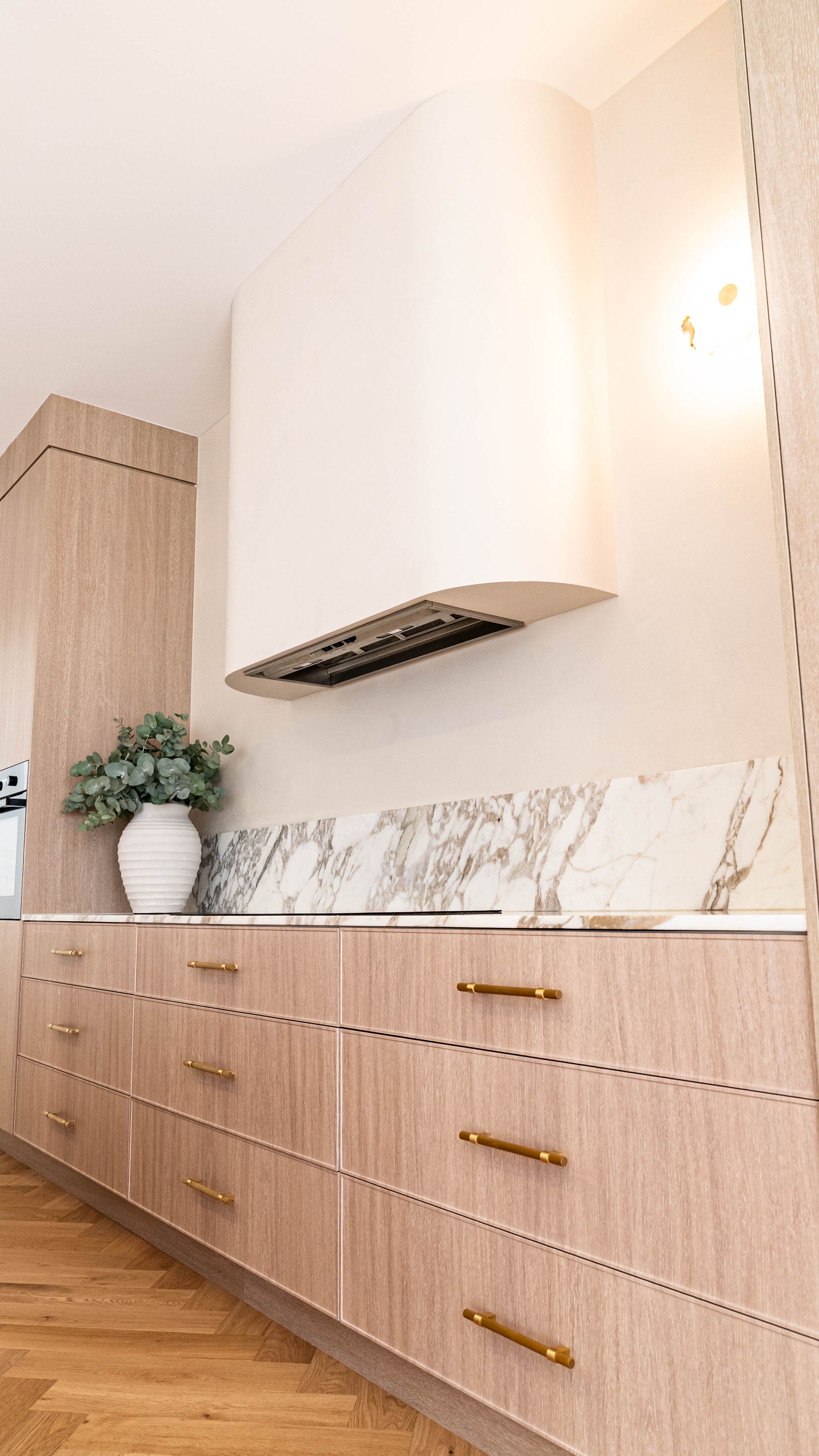 A Modern Kitchen Featuring Light Wood Cabinetry, a Marble Backsplash — Elite Stone in Tweed Heads South, NSW