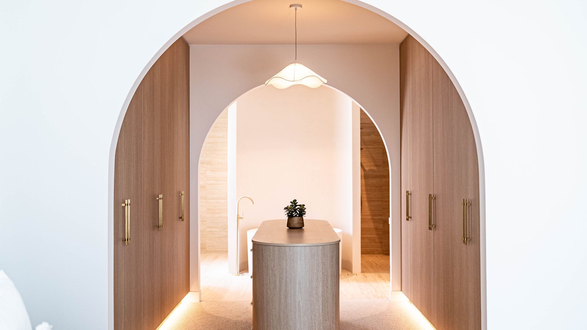 A Hallway With Wooden Cabinet, Leading to Central Island Under a Modern Light Fixture — Elite Stone in Tweed Heads South, NSW