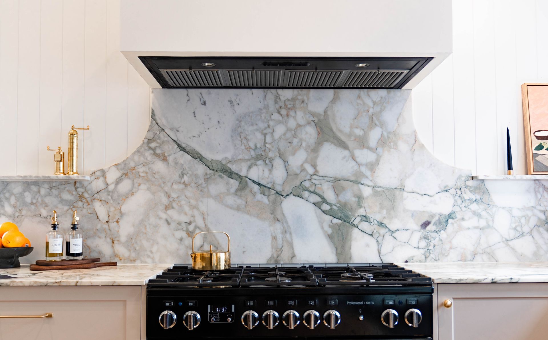 A Kitchen Stove With a Black Range Set Against a Dramatic Marble Backsplash — Elite Stone in Tweed Heads South, NSW