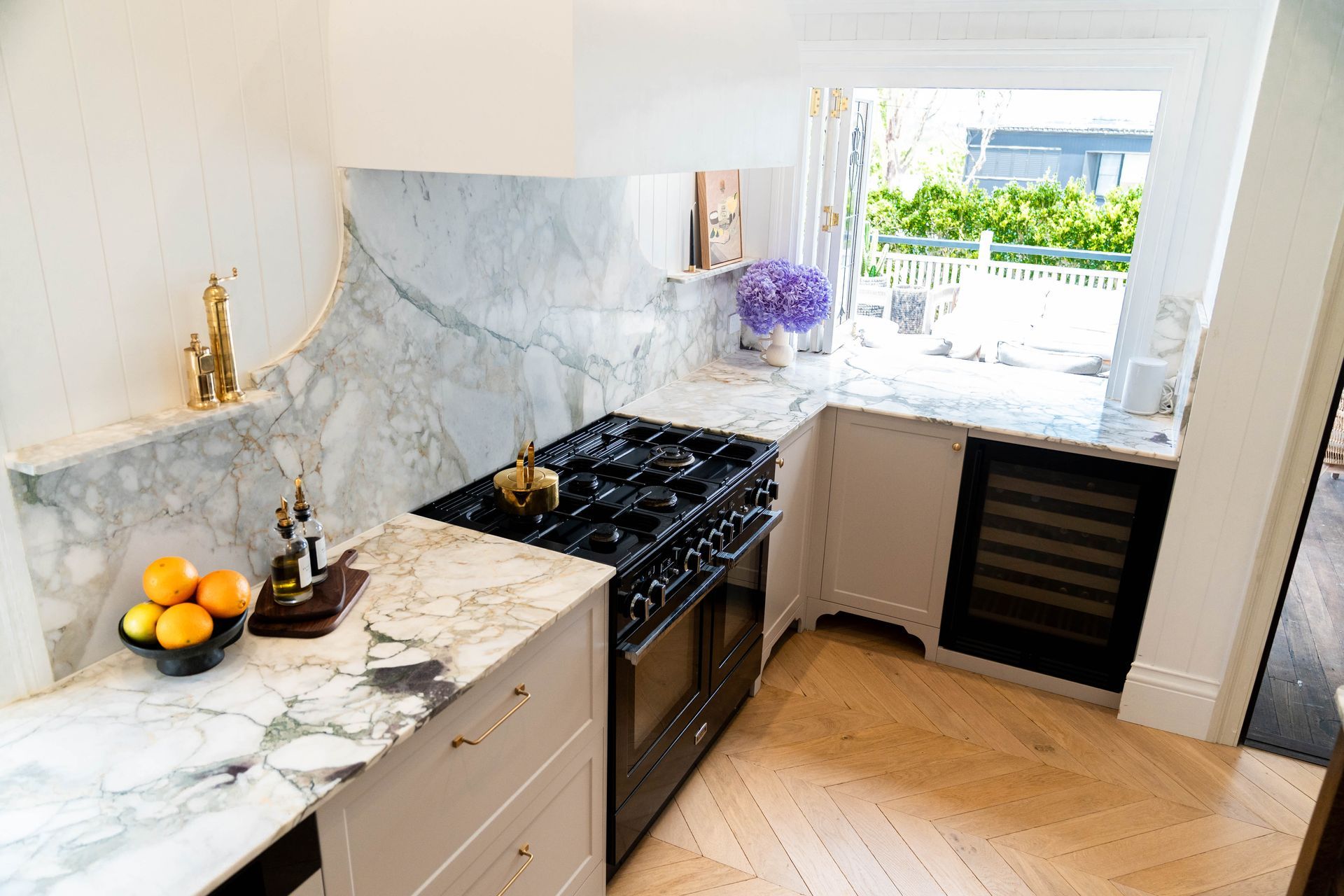 A Bright Kitchen Featuring Marble Countertops and a Window With Garden Views — Elite Stone in Tweed Heads South, NSW