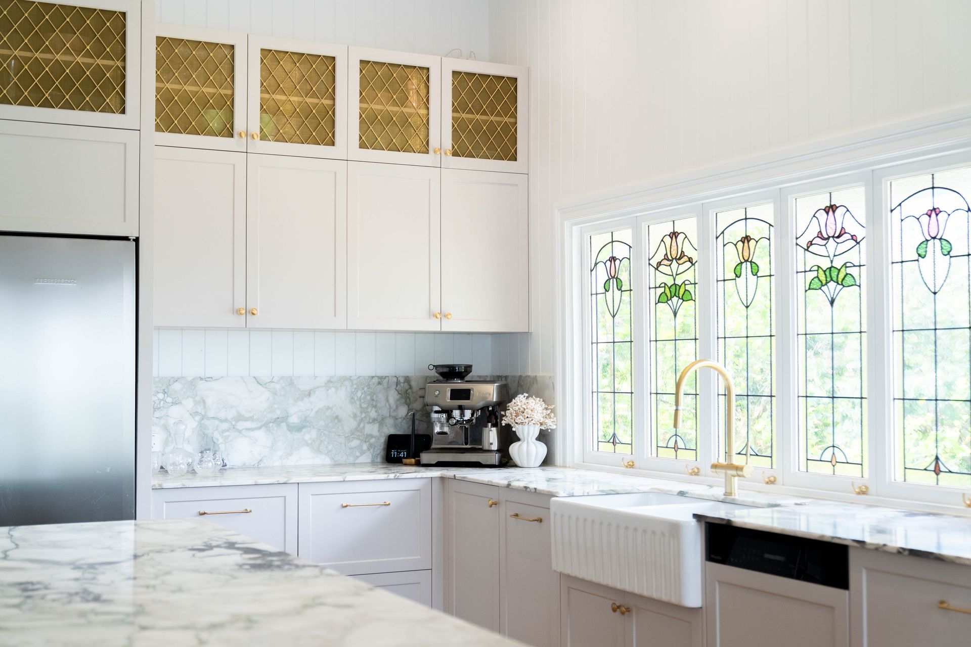 White Kitchen With Marble Countertops, Patterned Gold Cabinet Inserts — Elite Stone in Tweed Heads South, NSW
