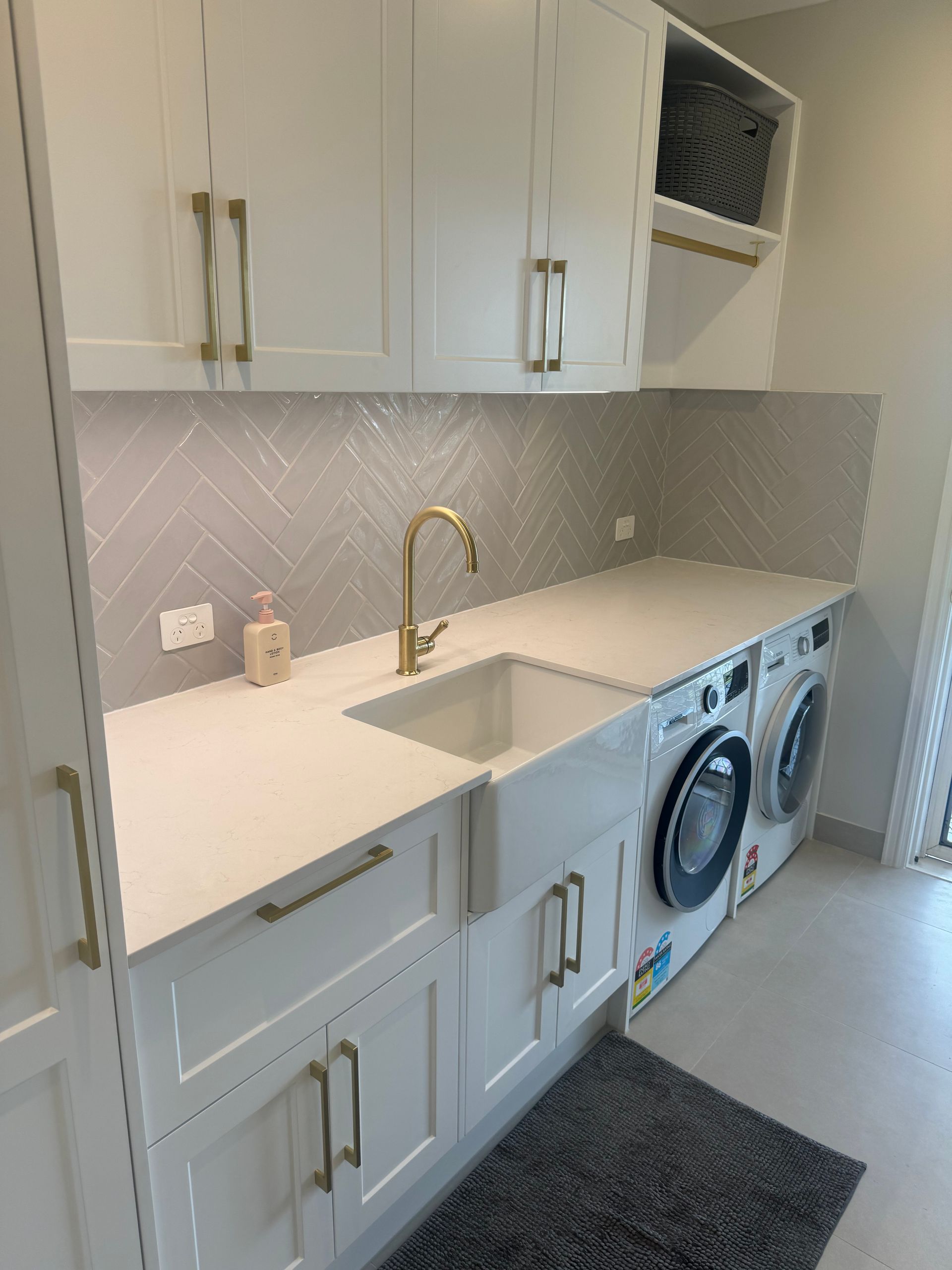 A Bathroom With a Bathtub, Toilet, Sink and Mirror — Elite Stone in Tweed Heads South, NSW