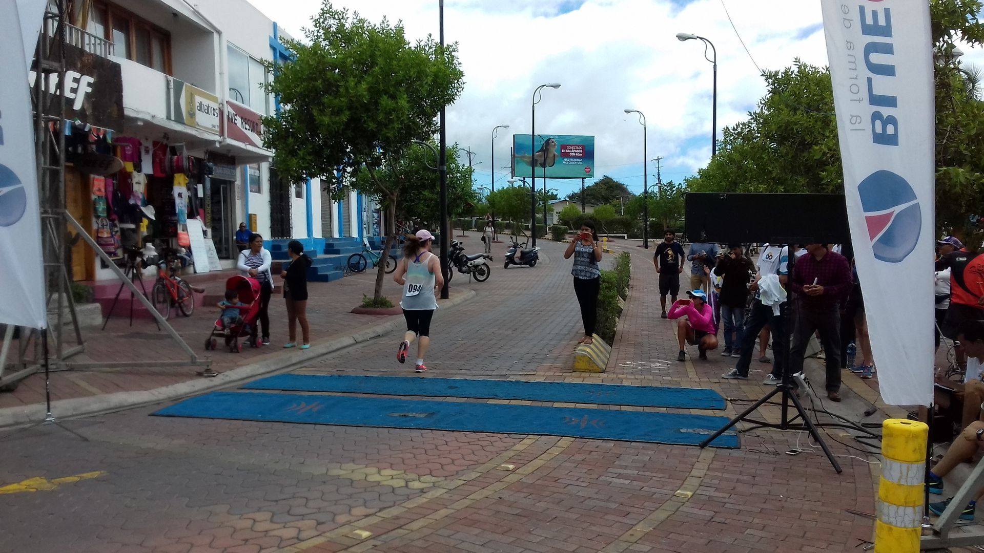 A person running on a street with a banner that says brune